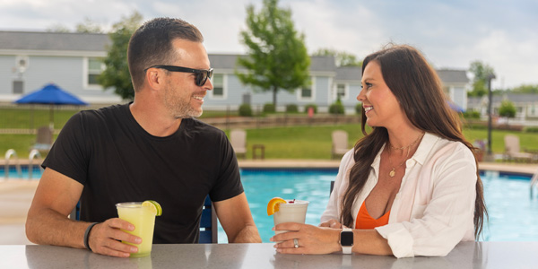 A couple having poolside drinks at The Lodge at Geneva